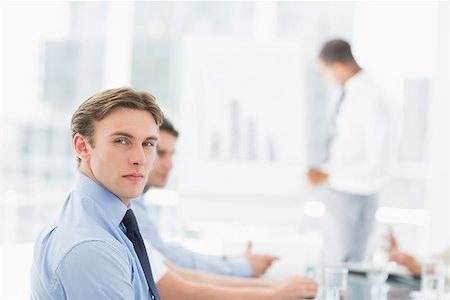 simsearch:400-07275394,k - Serious businessman looking at camera during a meeting in the office Stock Photo - Budget Royalty-Free & Subscription, Code: 400-07275414