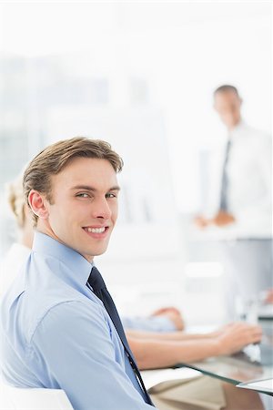 simsearch:400-07275394,k - Happy businessman looking at camera during a meeting in the office Stock Photo - Budget Royalty-Free & Subscription, Code: 400-07275416