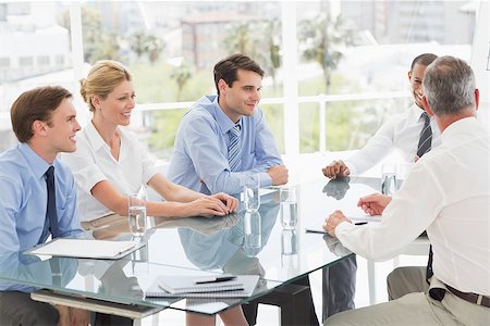 simsearch:400-07275394,k - Smiling business people talking during a meeting in the office Stock Photo - Budget Royalty-Free & Subscription, Code: 400-07275419