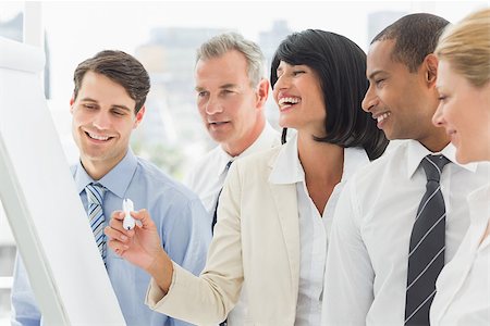 simsearch:400-07275394,k - Colleagues watching laughing businesswoman write on whiteboard in the office Stock Photo - Budget Royalty-Free & Subscription, Code: 400-07275434