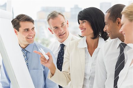 simsearch:400-07275394,k - Colleagues watching happy businesswoman pointing to whiteboard in the office Stock Photo - Budget Royalty-Free & Subscription, Code: 400-07275435