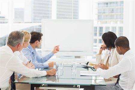 Business people looking at blank whiteboard in conference room in the office Stock Photo - Budget Royalty-Free & Subscription, Code: 400-07275440