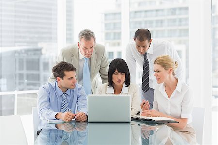 simsearch:400-07275394,k - Business people gathered around laptop talking in the office Stock Photo - Budget Royalty-Free & Subscription, Code: 400-07275451