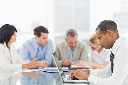 simsearch:400-08136433,k - Businessman using laptop during a meeting in the office Foto de stock - Super Valor sin royalties y Suscripción, Código: 400-07275462