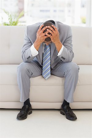 simsearch:400-07833287,k - Stressed businessman sitting on couch in the office Stock Photo - Budget Royalty-Free & Subscription, Code: 400-07275567