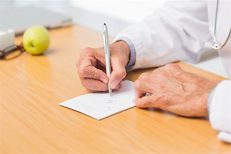simsearch:614-06898452,k - Doctor sitting at his desk writing out a prescription in his office at the hospital Stock Photo - Budget Royalty-Free & Subscription, Code: 400-07275593