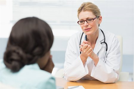 doctor with ethnic patient in office - Concerned doctor listening to her patient in an office at the hospital Stock Photo - Budget Royalty-Free & Subscription, Code: 400-07275619