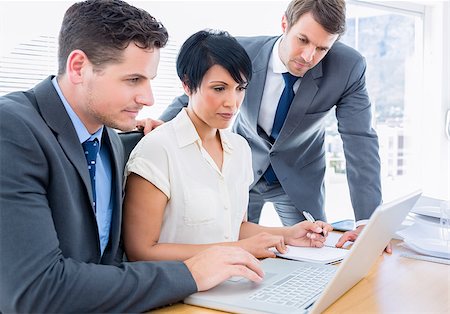 simsearch:400-05663929,k - Smartly dressed young colleagues using laptop at office desk Stock Photo - Budget Royalty-Free & Subscription, Code: 400-07275704