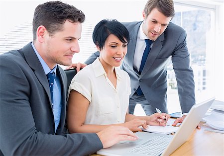 simsearch:400-05663929,k - Smartly dressed young colleagues using laptop at office desk Stock Photo - Budget Royalty-Free & Subscription, Code: 400-07275705
