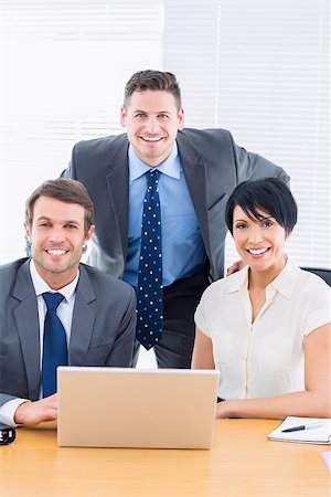 simsearch:400-05663929,k - Portrait of smartly dressed young colleagues with laptop at office desk Stock Photo - Budget Royalty-Free & Subscription, Code: 400-07275702