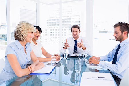 simsearch:400-07274497,k - Smartly dressed young executives sitting around conference table in office Stock Photo - Budget Royalty-Free & Subscription, Code: 400-07275905