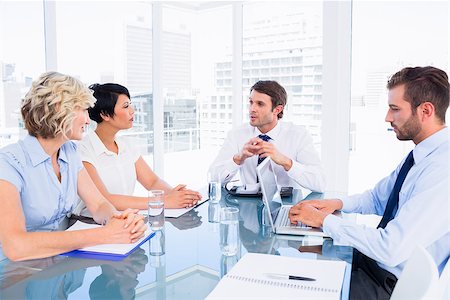 simsearch:400-07274497,k - Smartly dressed young executives sitting around conference table in office Stock Photo - Budget Royalty-Free & Subscription, Code: 400-07275907