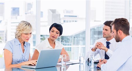 simsearch:400-07274497,k - Smartly dressed young executives sitting around conference table in office Stock Photo - Budget Royalty-Free & Subscription, Code: 400-07275908