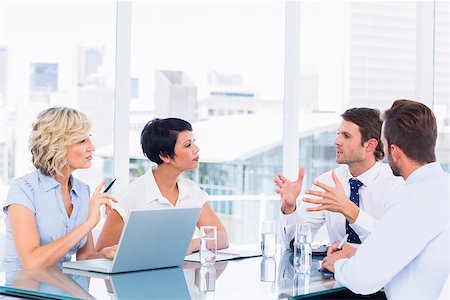 simsearch:400-07274497,k - Smartly dressed young executives sitting around conference table in office Stock Photo - Budget Royalty-Free & Subscription, Code: 400-07275909