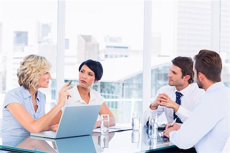 simsearch:400-07274497,k - Smartly dressed young executives sitting around conference table in office Stock Photo - Budget Royalty-Free & Subscription, Code: 400-07275910