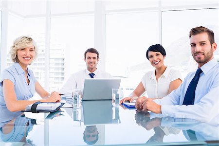 simsearch:400-07274497,k - Smartly dressed young executives sitting around conference table in office Stock Photo - Budget Royalty-Free & Subscription, Code: 400-07275911