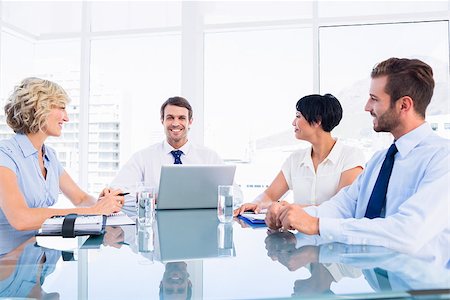 simsearch:400-07274497,k - Smartly dressed young executives sitting around conference table in office Stock Photo - Budget Royalty-Free & Subscription, Code: 400-07275912