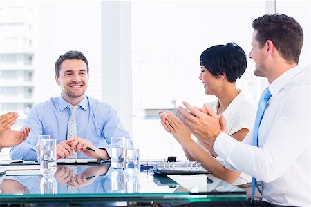 executives applauding - Business executives clapping around conference table in a bright office Stock Photo - Budget Royalty-Free & Subscription, Code: 400-07275927