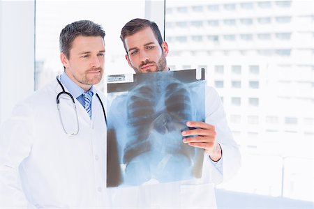 simsearch:400-07778150,k - Two male doctors examining xray in a bright medical office Stock Photo - Budget Royalty-Free & Subscription, Code: 400-07275977