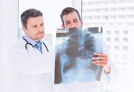 simsearch:400-07778150,k - Two male doctors examining xray in a bright medical office Stock Photo - Budget Royalty-Free & Subscription, Code: 400-07275978