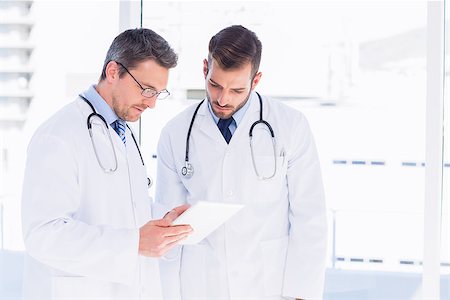 simsearch:400-07334526,k - Portrait of two male doctors using digital tablet in a bright medical office Stockbilder - Microstock & Abonnement, Bildnummer: 400-07275983