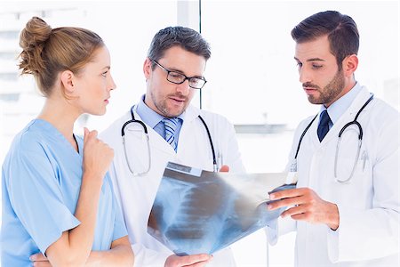 simsearch:400-07778150,k - Two male doctors and surgeon examining xray at the medical office Stock Photo - Budget Royalty-Free & Subscription, Code: 400-07275990