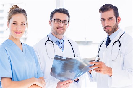 simsearch:400-07778150,k - Portrait of two male doctors and surgeon with xray report at the medical office Stock Photo - Budget Royalty-Free & Subscription, Code: 400-07275991