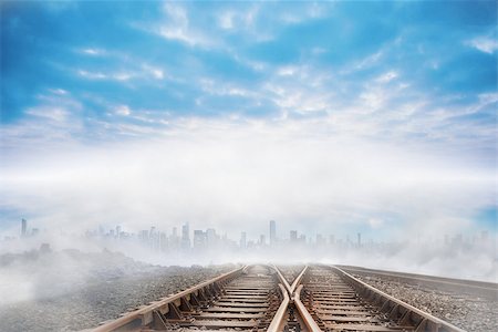 simsearch:400-07446838,k - Train tracks leading to city on the horizon Photographie de stock - Aubaine LD & Abonnement, Code: 400-07277214