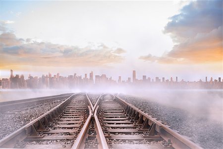 simsearch:400-07446838,k - Train tracks leading to misty city on the horizon Photographie de stock - Aubaine LD & Abonnement, Code: 400-07277216