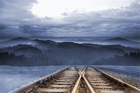 simsearch:400-07446838,k - Train tracks leading to misty mountains Photographie de stock - Aubaine LD & Abonnement, Code: 400-07277219