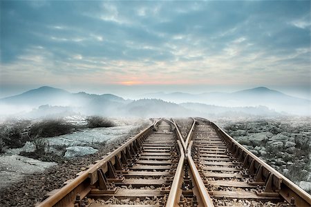 simsearch:400-07446838,k - Railway tracks leading to misty mountains Photographie de stock - Aubaine LD & Abonnement, Code: 400-07277226