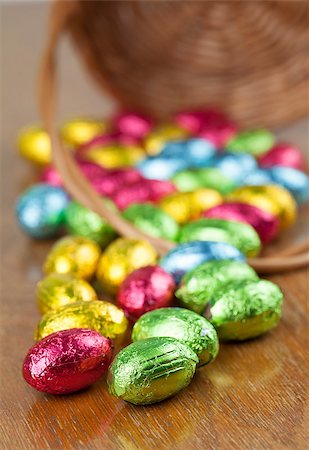 simsearch:400-04348779,k - Colorful chocolate Easter eggs on the table and basket in background. Shallow dof Fotografie stock - Microstock e Abbonamento, Codice: 400-07277429