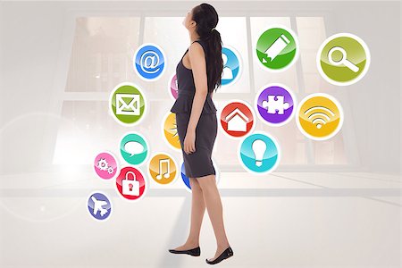 simsearch:400-07277726,k - Asian businesswoman walking against bright blue room with windows Stock Photo - Budget Royalty-Free & Subscription, Code: 400-07277594