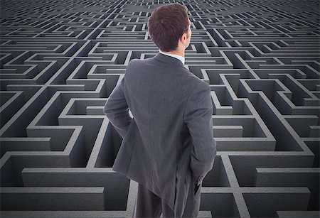 simsearch:400-07446676,k - Businessman standing with hands on hips against difficult maze puzzle Foto de stock - Super Valor sin royalties y Suscripción, Código: 400-07277596