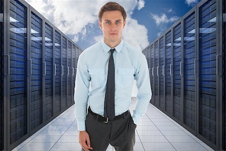 simsearch:400-07448129,k - Serious businessman with hand in pocket against server hallway in the sky Stock Photo - Budget Royalty-Free & Subscription, Code: 400-07277872