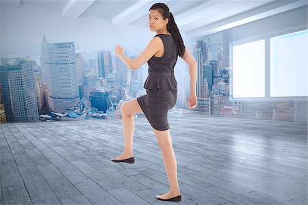 simsearch:400-07277816,k - Businesswoman stepping up against city scene in a room Fotografie stock - Microstock e Abbonamento, Codice: 400-07278126