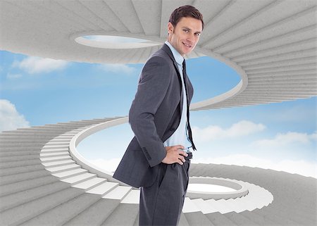 person on winding stairs - Smiling businessman with hands on hips against spiral staircase in the sky Stock Photo - Budget Royalty-Free & Subscription, Code: 400-07278353