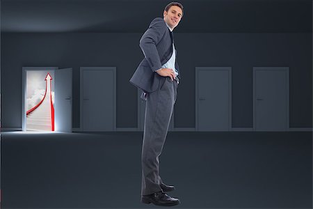 simsearch:400-08020381,k - Happy businessman with hands on hips against door opening to show red arrow and sky Fotografie stock - Microstock e Abbonamento, Codice: 400-07278417