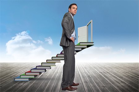 pile hands bussiness - Serious businessman with hands on hips against book steps against sky Stock Photo - Budget Royalty-Free & Subscription, Code: 400-07278446