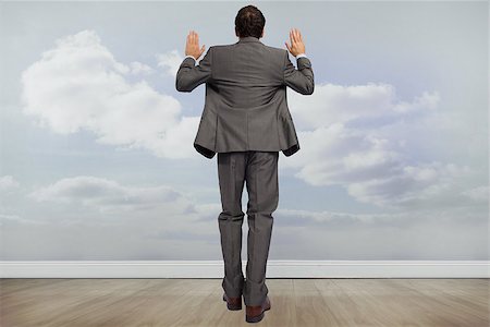 simsearch:400-07665425,k - Businessman posing with hands up against clouds in a room Stockbilder - Microstock & Abonnement, Bildnummer: 400-07278467