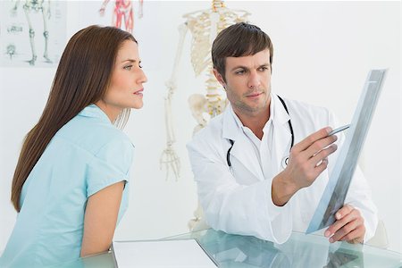 simsearch:400-07778150,k - Side view of a male doctor explaining x-ray to female patient in the medical office Stock Photo - Budget Royalty-Free & Subscription, Code: 400-07270843