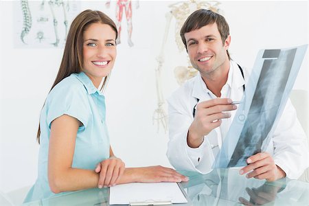 simsearch:400-07269250,k - Portrait of a smiling male doctor explaining spine x-ray to female patient in the medical office Stock Photo - Budget Royalty-Free & Subscription, Code: 400-07270852