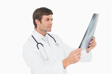 simsearch:400-04552598,k - Concentrated male doctor looking at x-ray picture of lungs over white background Foto de stock - Super Valor sin royalties y Suscripción, Código: 400-07270918