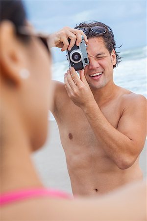 simsearch:400-08291180,k - Man & woman couple, boyfriend taking vacation photograph of his girlfriend in a bikini at the beach using a digital camera Foto de stock - Royalty-Free Super Valor e Assinatura, Número: 400-07272429