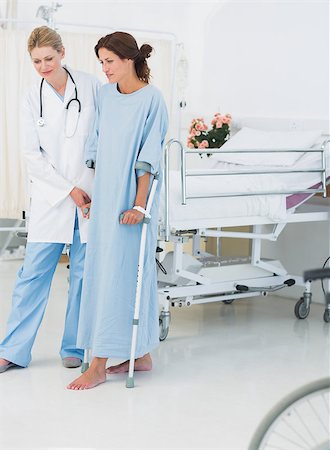 Full length of a doctor helping patient in crutches at the hospital Stock Photo - Budget Royalty-Free & Subscription, Code: 400-07273167