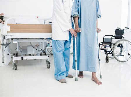 Low section of a doctor helping patient in crutches at the hospital Stock Photo - Budget Royalty-Free & Subscription, Code: 400-07273171