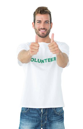 simsearch:400-07273307,k - Portrait of a happy male volunteer gesturing thumbs up over white background Stockbilder - Microstock & Abonnement, Bildnummer: 400-07273243