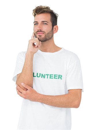 simsearch:400-07273307,k - Thoughtful young male volunteer standing over white background Stockbilder - Microstock & Abonnement, Bildnummer: 400-07273257