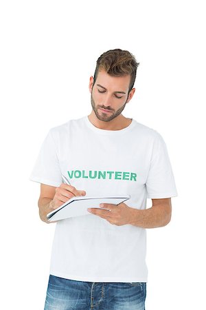 Young male volunteer writing a note over white background Foto de stock - Super Valor sin royalties y Suscripción, Código: 400-07273251