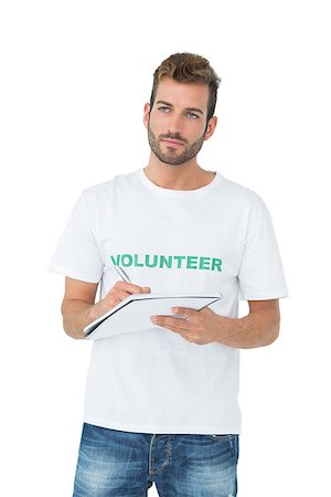 simsearch:400-07273307,k - Young male volunteer writing a note over white background Stockbilder - Microstock & Abonnement, Bildnummer: 400-07273252